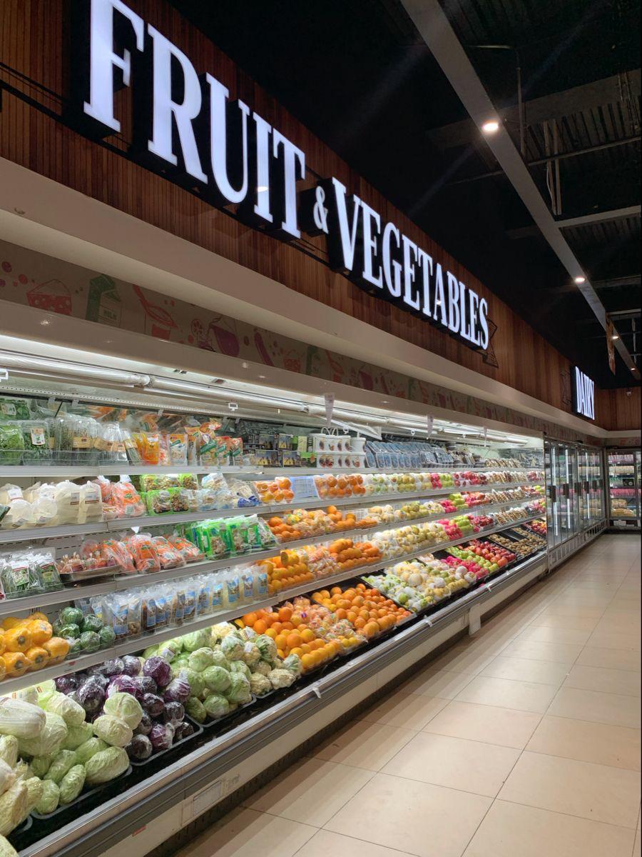 A fruit and vegetable aisle running the length of the shop